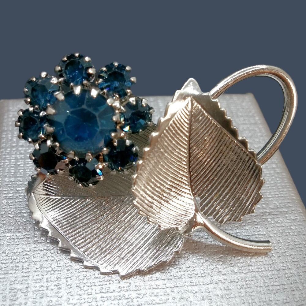 Vintage Silver Tone Flower Brooch Blue Rhinestones Prong Setting Textured Leaves